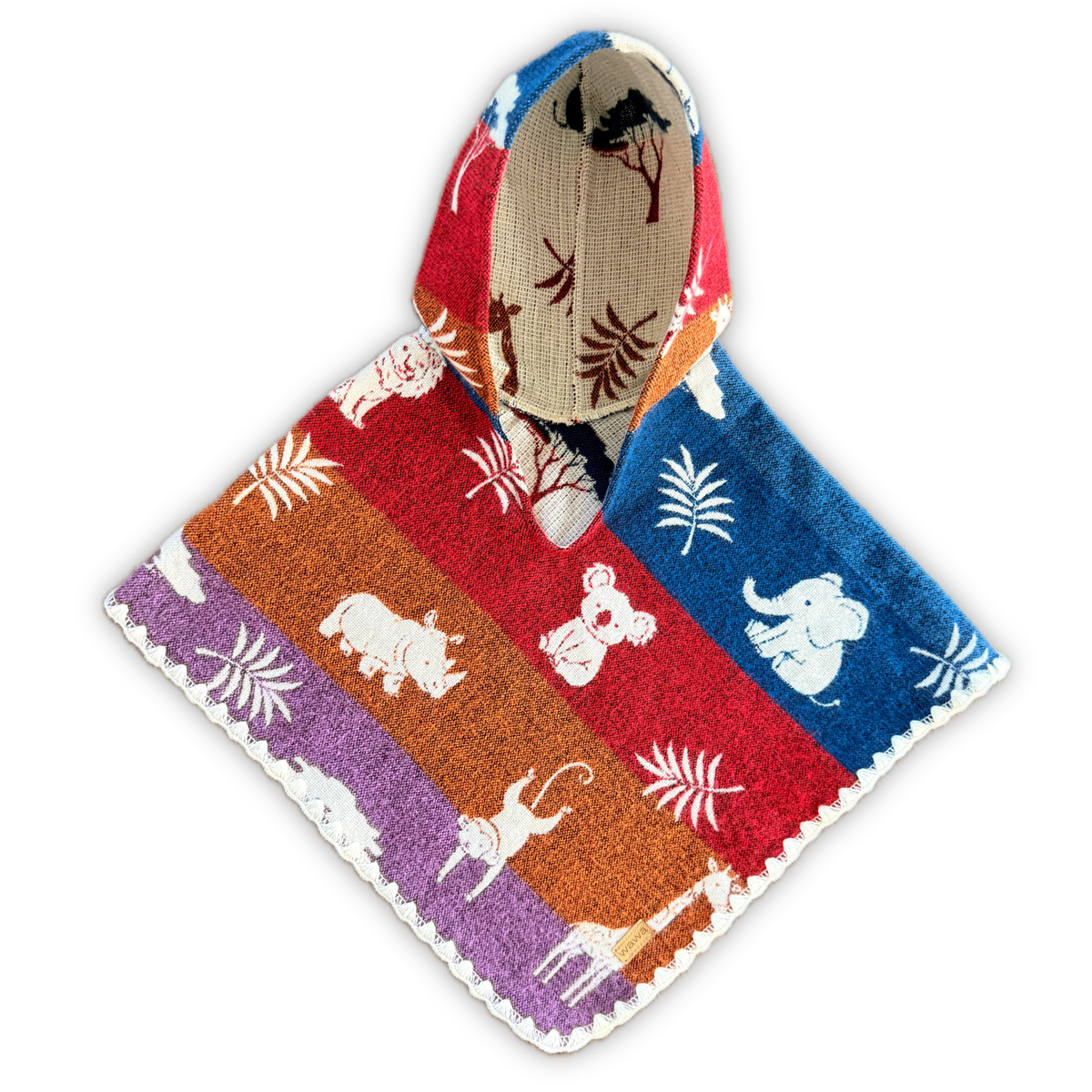 A hooded baby poncho with a colorful striped pattern featuring red, orange, purple, and blue bands, decorated with white animal silhouettes and palm leaf motifs. The interior hood lining shows a tree pattern on a beige background.